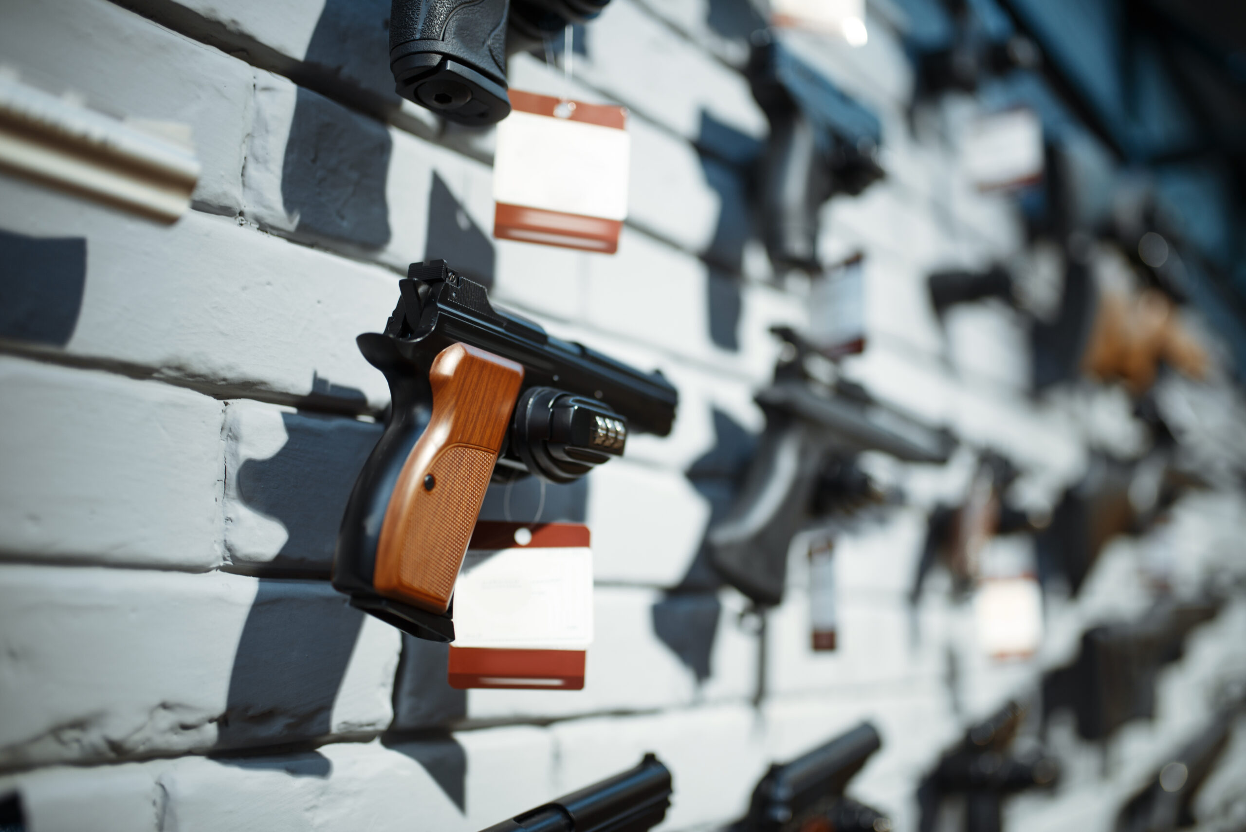 Handguns on showcase in gun shop closeup